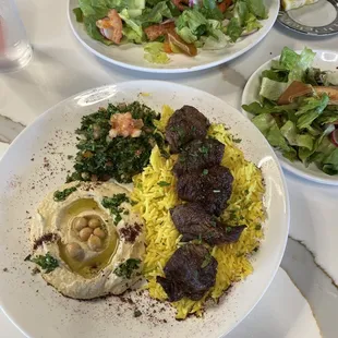 Beef kebab with rice, hummus, and tabbouleh