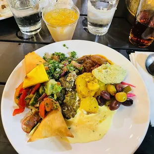 Tabouleh, potato&apos;s, stuffed grape leaves, veggie salad with kalamata olives, meat stuffed phyllo