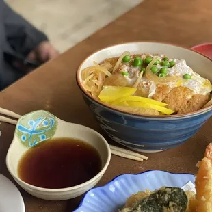 Tonkatsu donburi and a glimpse of tempura and the dipping sauce.