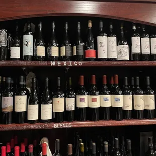 a shelf full of wine bottles