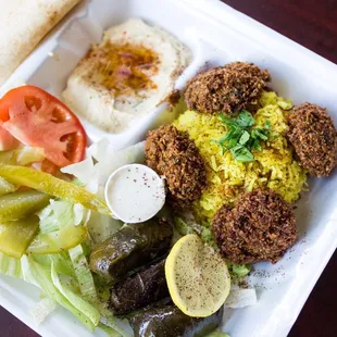 Veggie plate with home made hummus falfel baba ganoug grape leaves and salad.