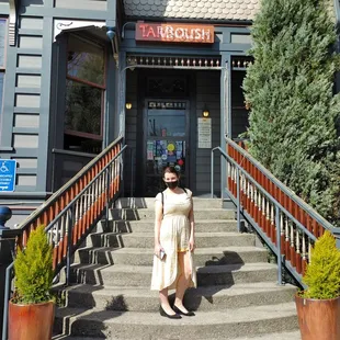 a woman standing in front of a restaurant