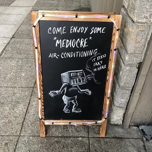 a chalk board with a drawing of a robot on it