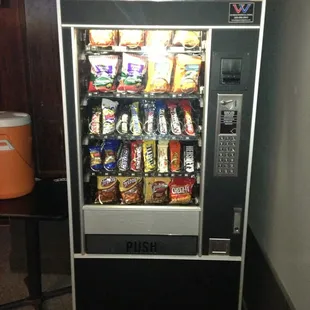 Vending machine with chips, candy, nuts, &amp; pork rinds.