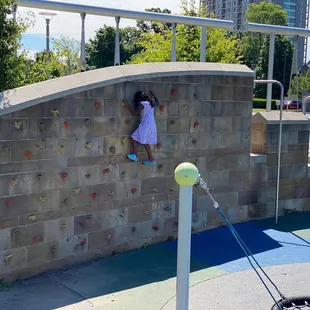Haniah scales the climbing wall.