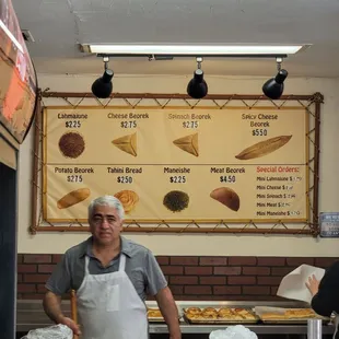 a man standing behind a counter