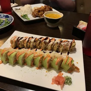 Playboy roll and Indy 500 roll, egg drop soup, orange chicken and edamame in the background.