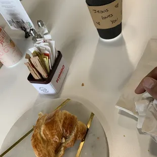 Coffee, croissant egg/ham sandwich, avocado toast with feta.