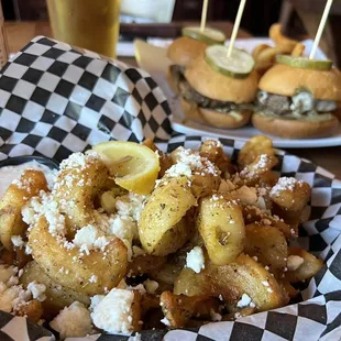 a basket of fried food and a bottle of beer