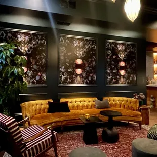 a living room with couches and a bar