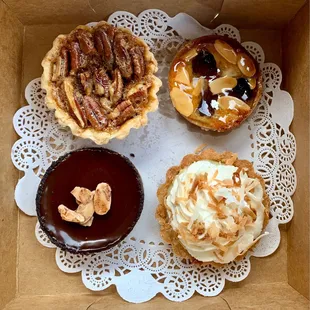 Clockwise from top left: Bourbon Pecan Tart, Cherry Almond Tart, Coconut Cream Tart, Chocolate Creme Brulee Tart