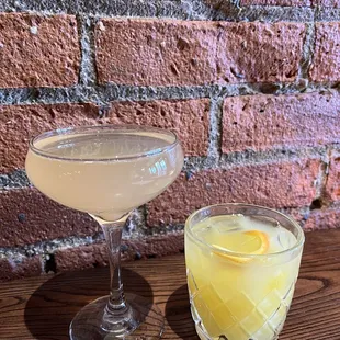 a glass of lemonade next to a glass of lemonade