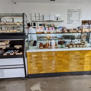a bakery counter with a variety of pastries