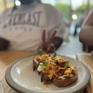 Burata tartine - 10! The sweet and savory combo is chefs kiss. 4 pieces so great share ale app.