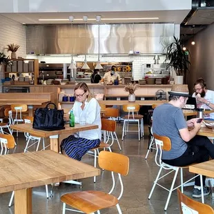 people sitting at tables in a restaurant