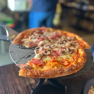 Pizza with soppressata and mushrooms