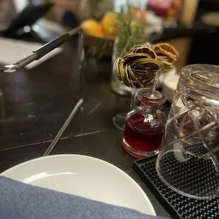 a table setting with a glass jar and a plate