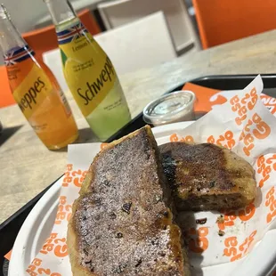 Hawawshi with ground beef in lamb fat with side of tahin and traditional, imported, Schweppes.