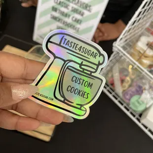 a hand holding a sticker