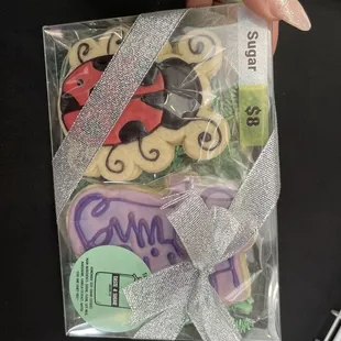 a hand holding a package of cookies