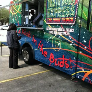 a woman ordering food from a food truck