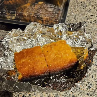 Burned cornbread...the foil isn't burned that's a shadow. The cornbread is black burned.