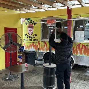 a man standing in front of a food truck