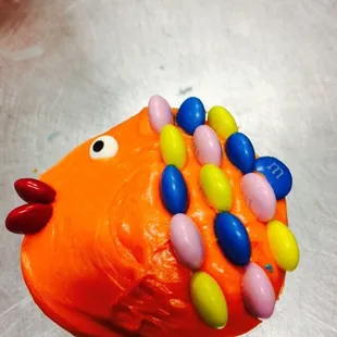 an orange fish with colorful candies