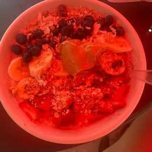 a bowl of oatmeal with fruit and nuts