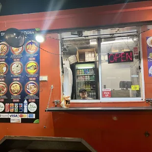walk-up view of food truck, peep the smiling, friendly owner working the truck! also peep the drink options in the fridge behind him ;)