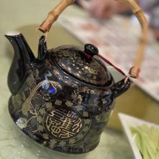 a teapot with a bamboo handle