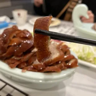 a bowl of food with chopsticks
