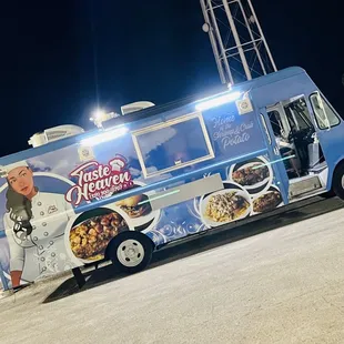 a blue food truck parked in a parking lot