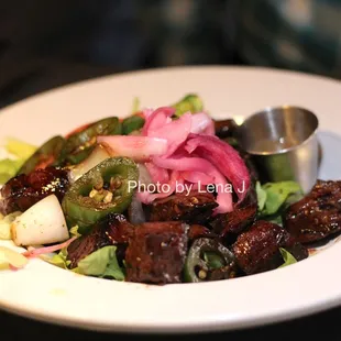 Shaking Beef ($29) - hanger steak, mixed greens, tomato, onion, jalapeño, citrus dressing