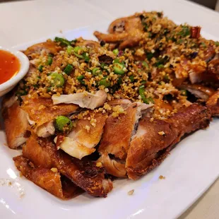 Roasted whole chicken seasoned in garlic &amp; salt. Crispy succulent moist meat. Very large portion. Eat with sweet sauce or without.