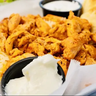 a plate of food with a side of dips