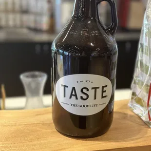 a growl of beer on a wooden table