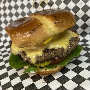 a hamburger with cheese and lettuce