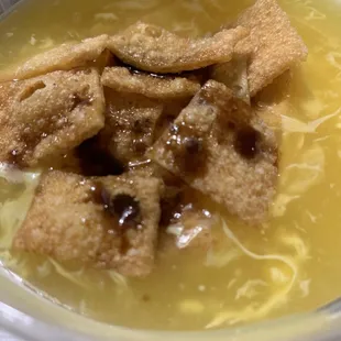 Egg drop soup with crispies on top.