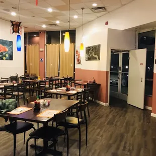 a dining area with tables and chairs