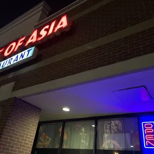 a neon sign on the outside of a restaurant