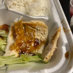 chicken, rice, and lettuce in a styrofoam container