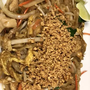 a plate of noodles with meat and vegetables