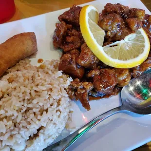 Orange chicken with fried rice and egg roll, delicious! Merry crispy and tasty.