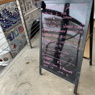 a menu on a sidewalk