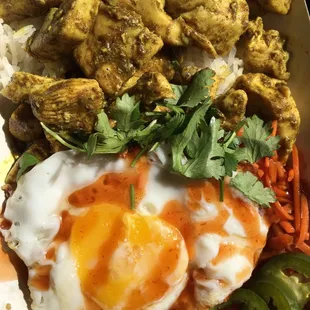 Curried chicken over jasmine rice with an over medium egg