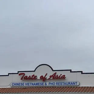 a white suv parked in front of a chinese restaurant