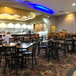 a dining area with tables and chairs