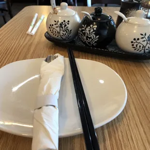 chopsticks and a plate with a napkin