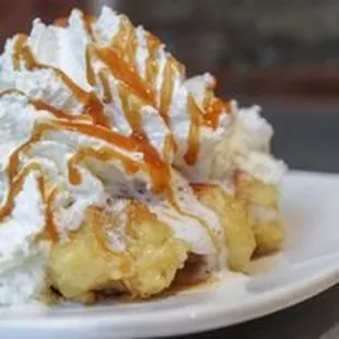a waffle with whipped cream and caramel